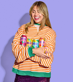 girl holding 4 swoon cans - raspberry tea, half tea half lemonade, lemon tea, peach tea